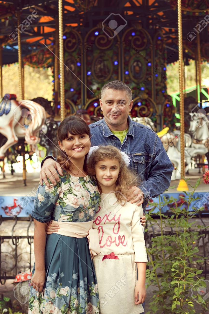 A normal happy family posing in the Park mom, dad and daughter 10 years fun walk in the summer Park - 66916421 A normal happy family posing in the Park mom, dad and daughter 10 years fun walk in the summer Park - 66916421
