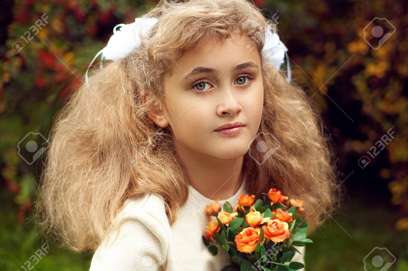 Beautiful teenage girl 10 years old, adorable face looking straight to the camera, kinky blonde in summer, outdoors, natural light in the evening - 66916762 Beautiful teenage girl 10 years old, adorable face looking straight to the camera, kinky blonde in summer, outdoors, natural light in the evening - 66916762