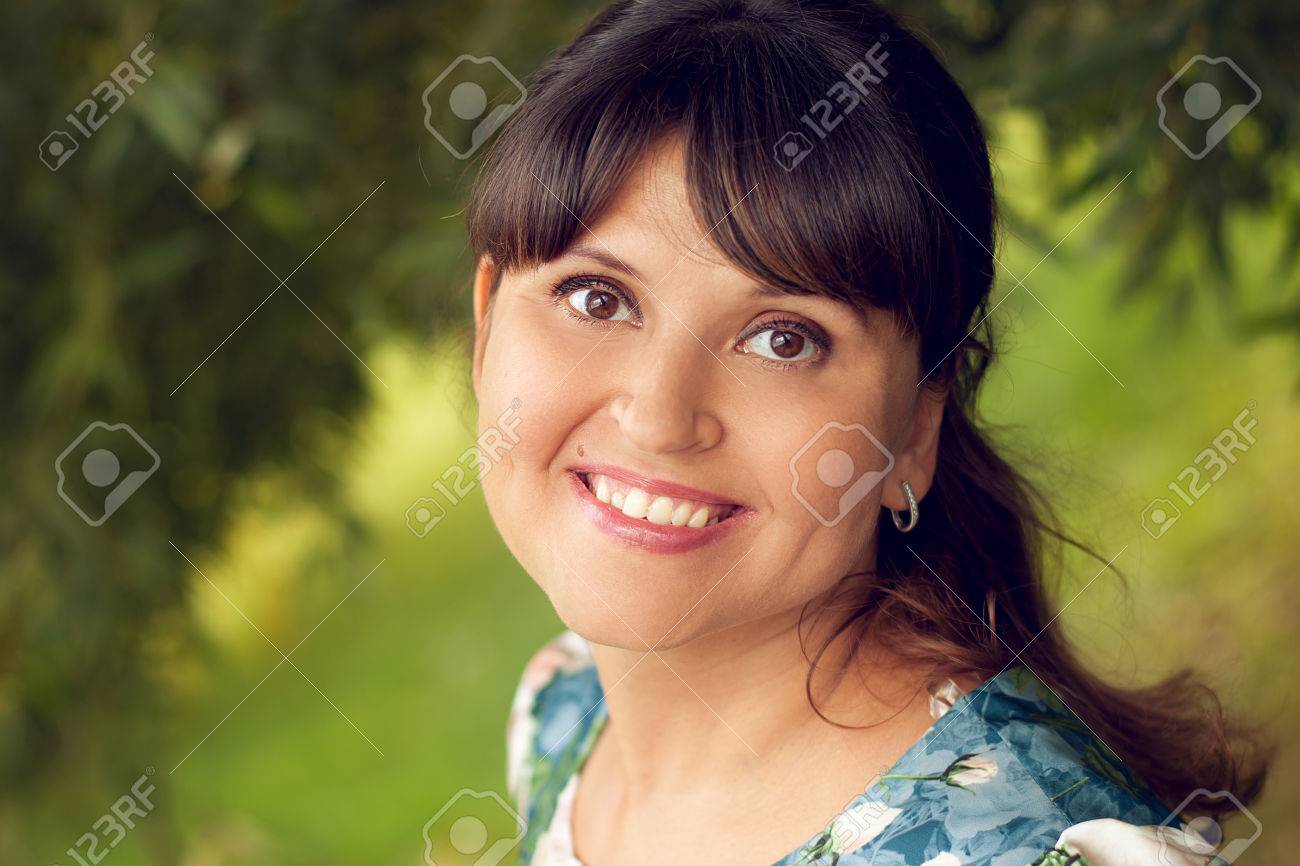 Beautiful happy young woman smiles white teeth, walking in summer Park - 66916822 Beautiful happy young woman smiles white teeth, walking in summer Park - 66916822