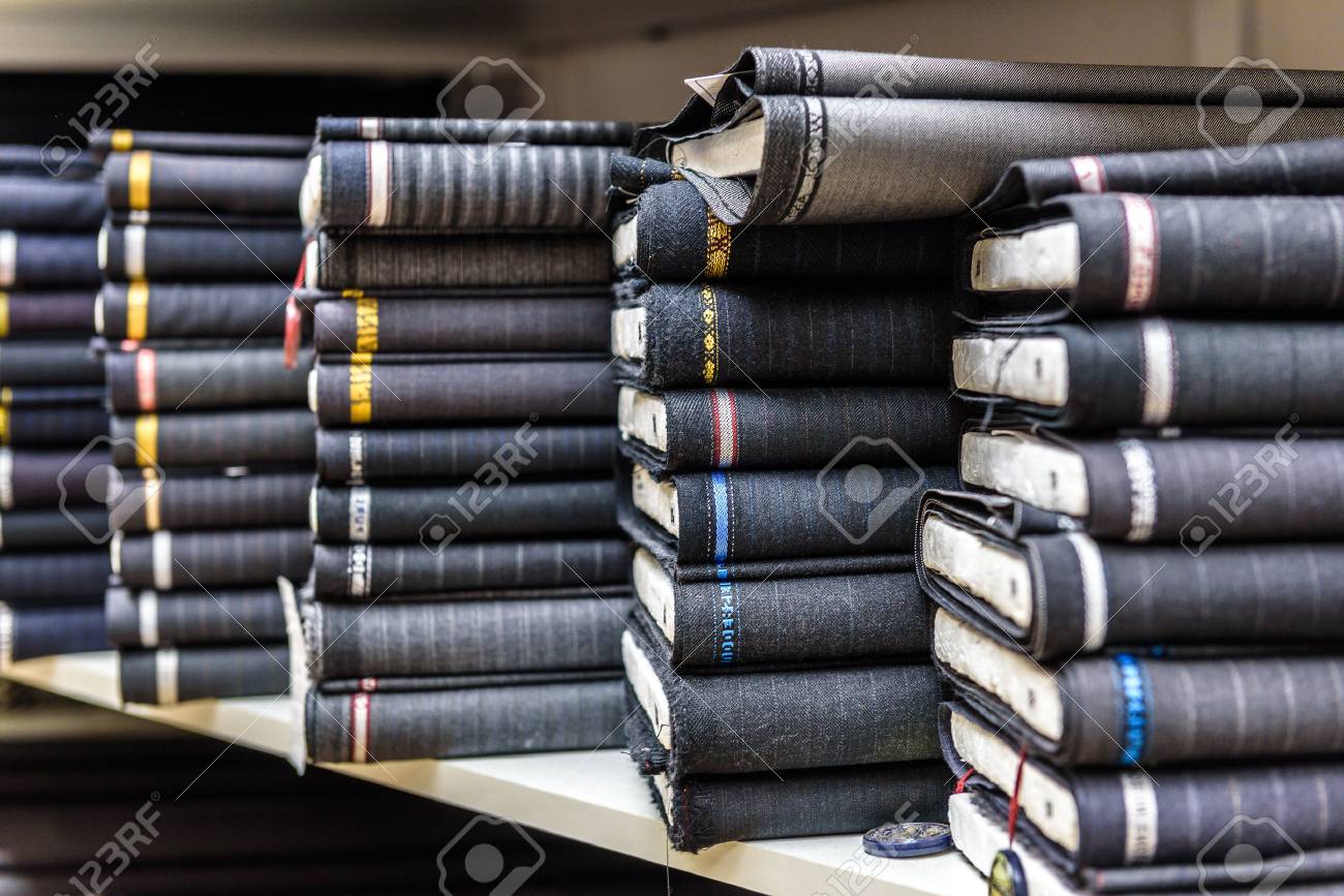 Rolls of fabric and textiles in a factory shop or store or bazar. Multi different fabric for men formal business suit on the market. Industrial fabrics. - 47547015 Rolls of fabric and textiles in a factory shop or store or bazar. Multi different fabric for men formal business suit on the market. Industrial fabrics. - 47547015