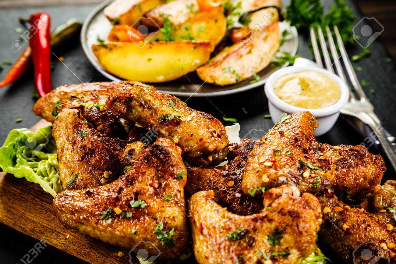 Roast Chicken Wings With Baked Potatoes Stock Photo Picture And Royalty Free Image Image 99513136
