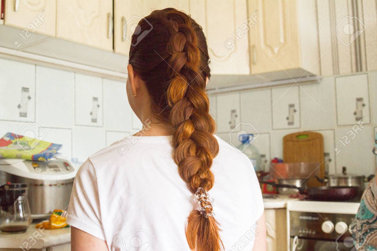 Girly Red Hair Braided Into A Braid With A Ponytail