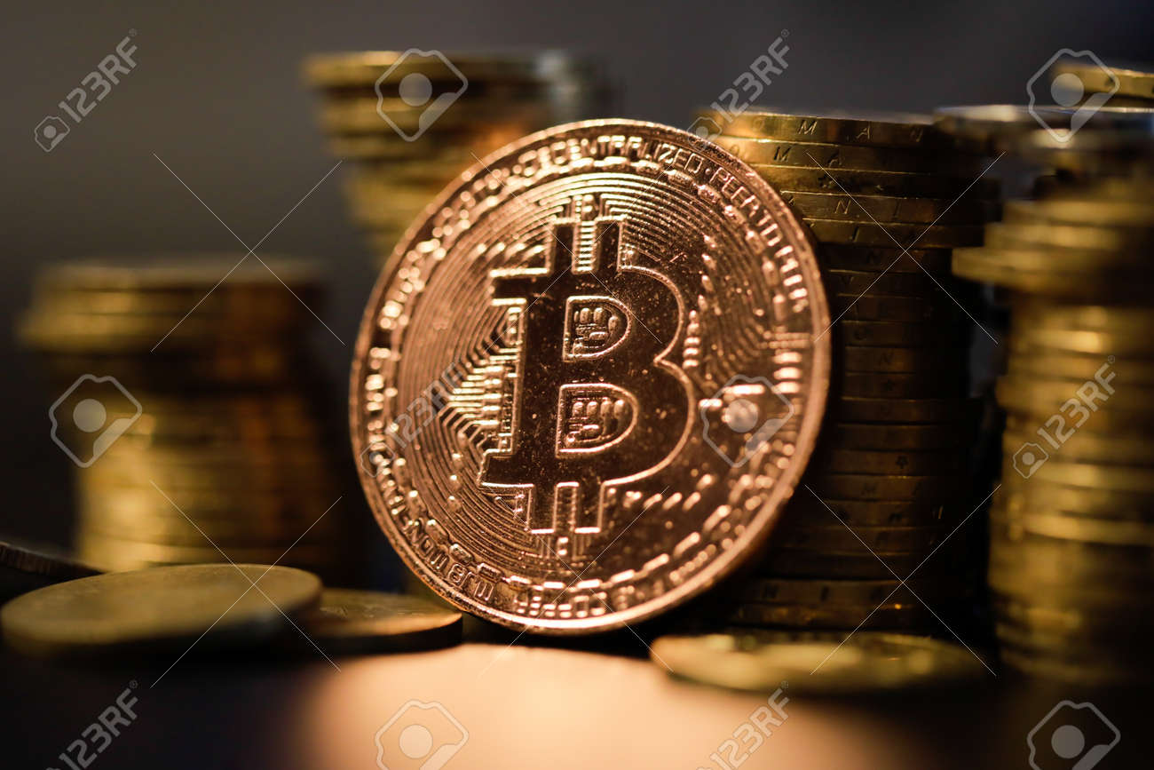 Shallow depth of field (selective focus) image with a Bitcoin metal coin near other metal coins - cryptocurrency concept. - 167104249 Shallow depth of field (selective focus) image with a Bitcoin metal coin near other metal coins - cryptocurrency concept. - 167104249