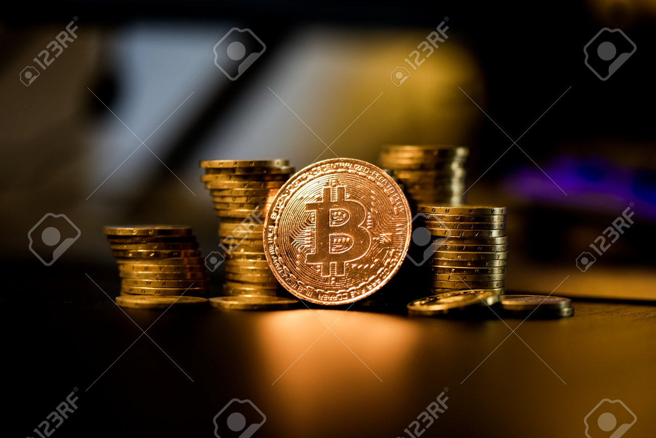 Shallow depth of field (selective focus) image with a Bitcoin metal coin near other metal coins - cryptocurrency concept. - 167104252 Shallow depth of field (selective focus) image with a Bitcoin metal coin near other metal coins - cryptocurrency concept. - 167104252