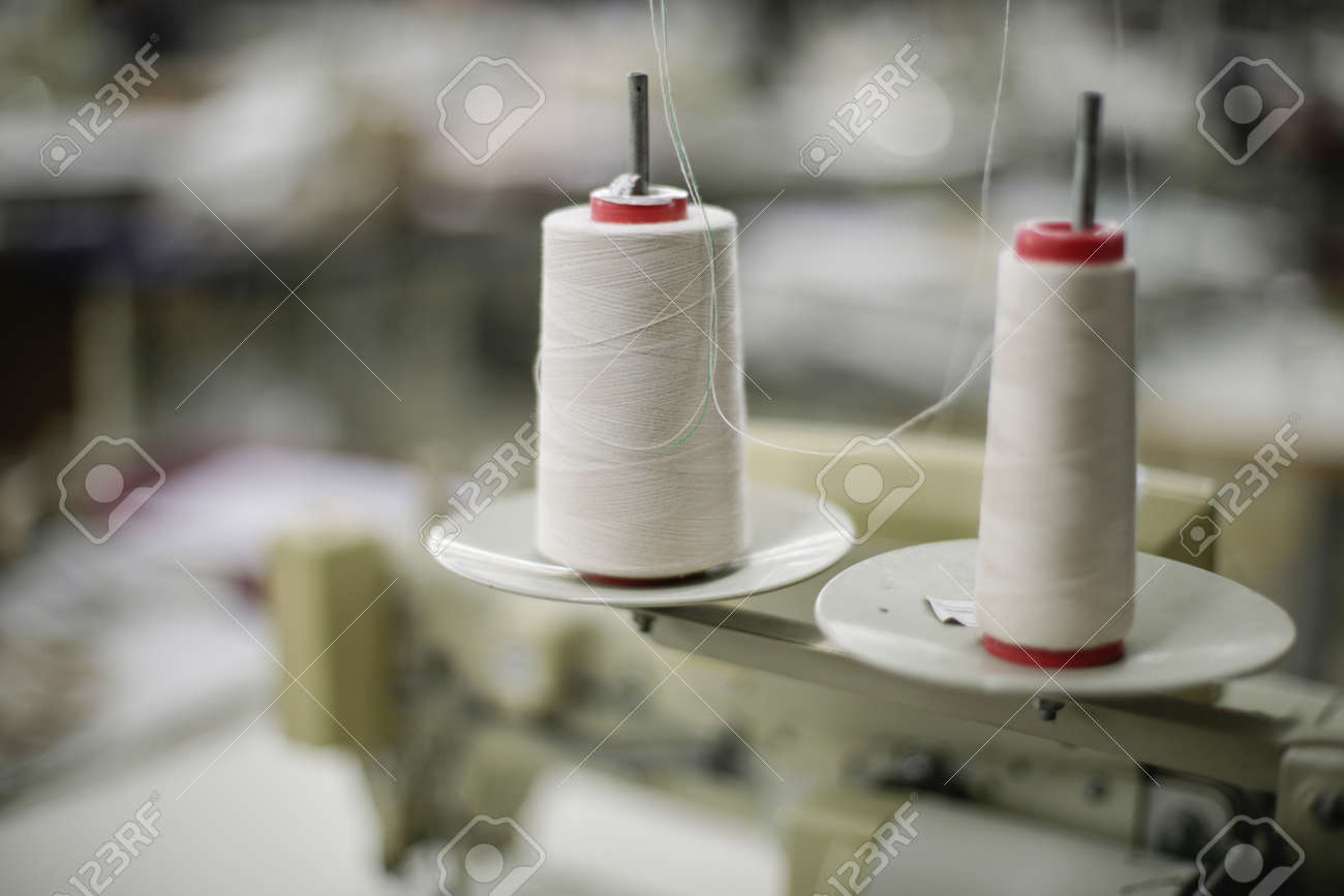Shallow depth of field (selective focus) image with thread spools in a textile factory. - 166661758 Shallow depth of field (selective focus) image with thread spools in a textile factory. - 166661758