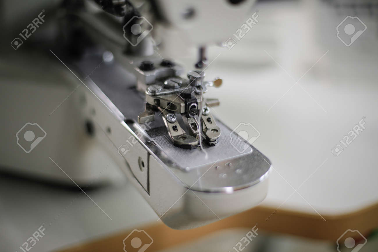 Shallow depth of field (selective focus) image with an electric sewing machine in a textile factory. - 166589054 Shallow depth of field (selective focus) image with an electric sewing machine in a textile factory. - 166589054
