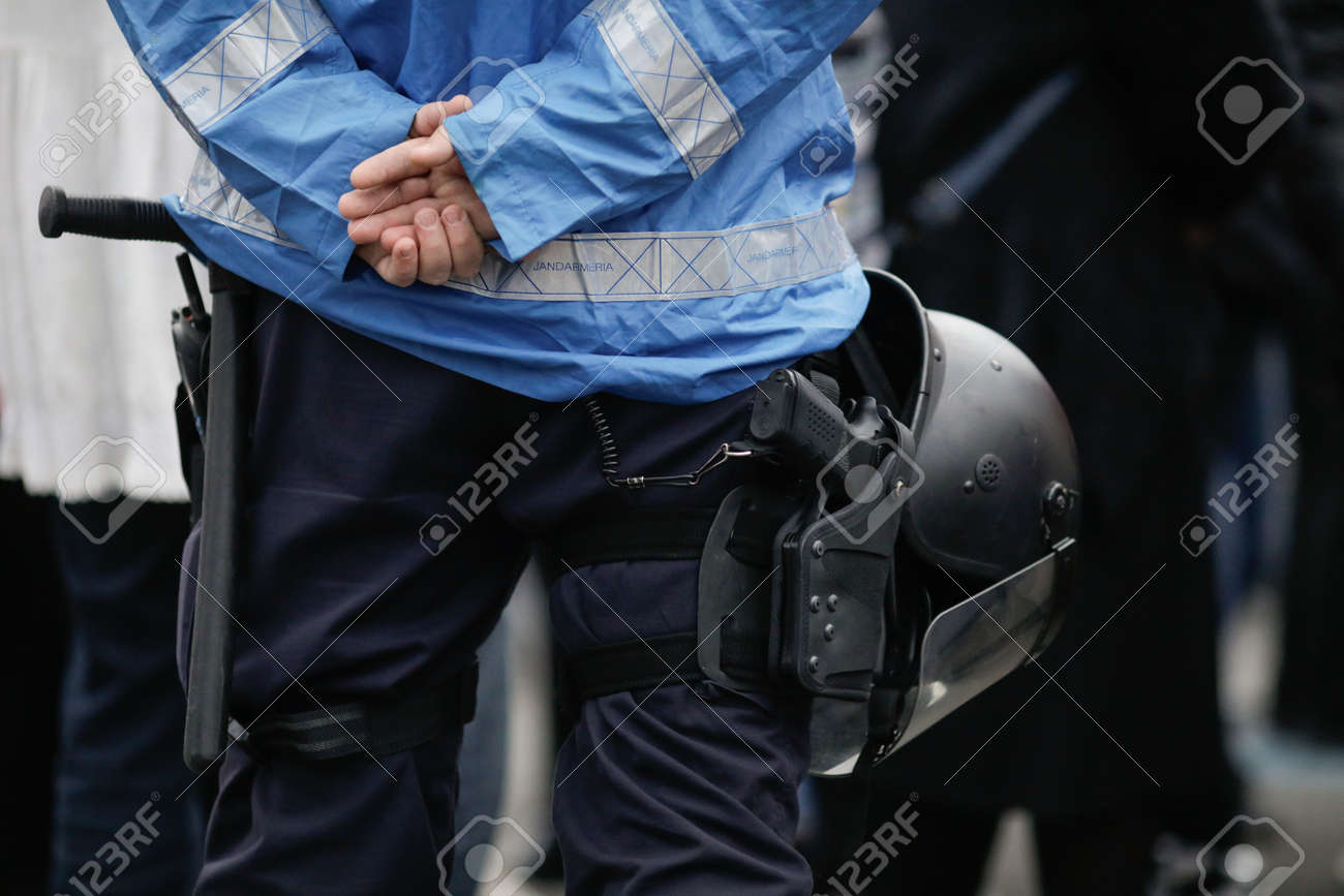 Bucharest, Romania - April 3, 2021: Details with the riot kit of a Romanian jandarm during a rally: gun, helmet, radio station, baton. - 167252061 Bucharest, Romania - April 3, 2021: Details with the riot kit of a Romanian jandarm during a rally: gun, helmet, radio station, baton. - 167252061
