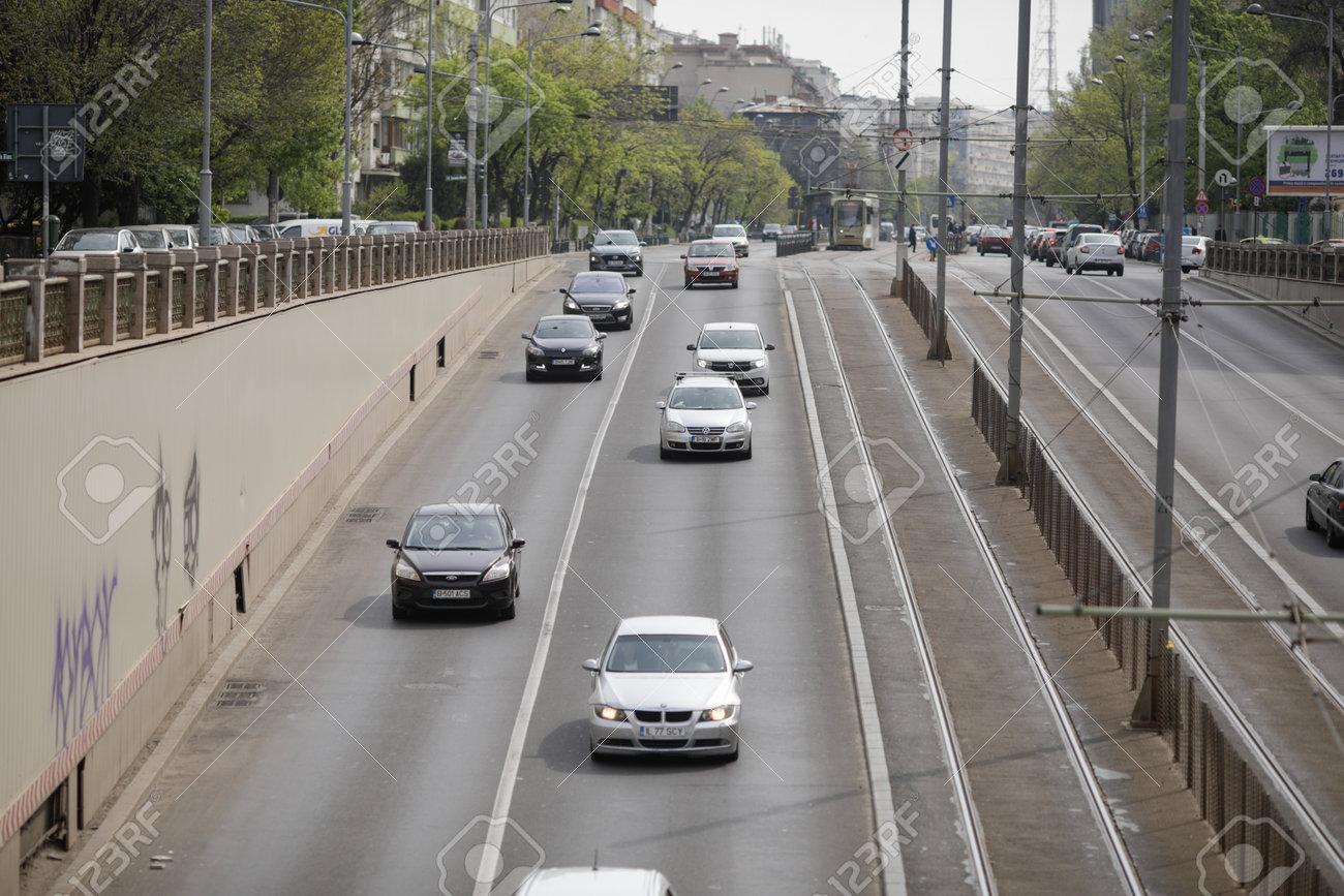 Bucharest, Romania - April 27, 2021: Cars in traffic in downtown Bucharest. - 168631296 Bucharest, Romania - April 27, 2021: Cars in traffic in downtown Bucharest. - 168631296