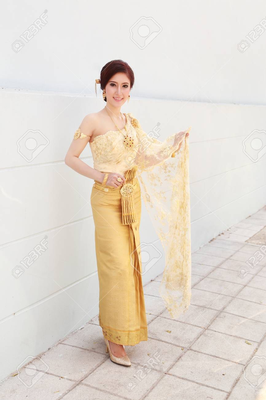 woman with Thai dress and wall background - 39191471 woman with Thai dress and wall background - 39191471