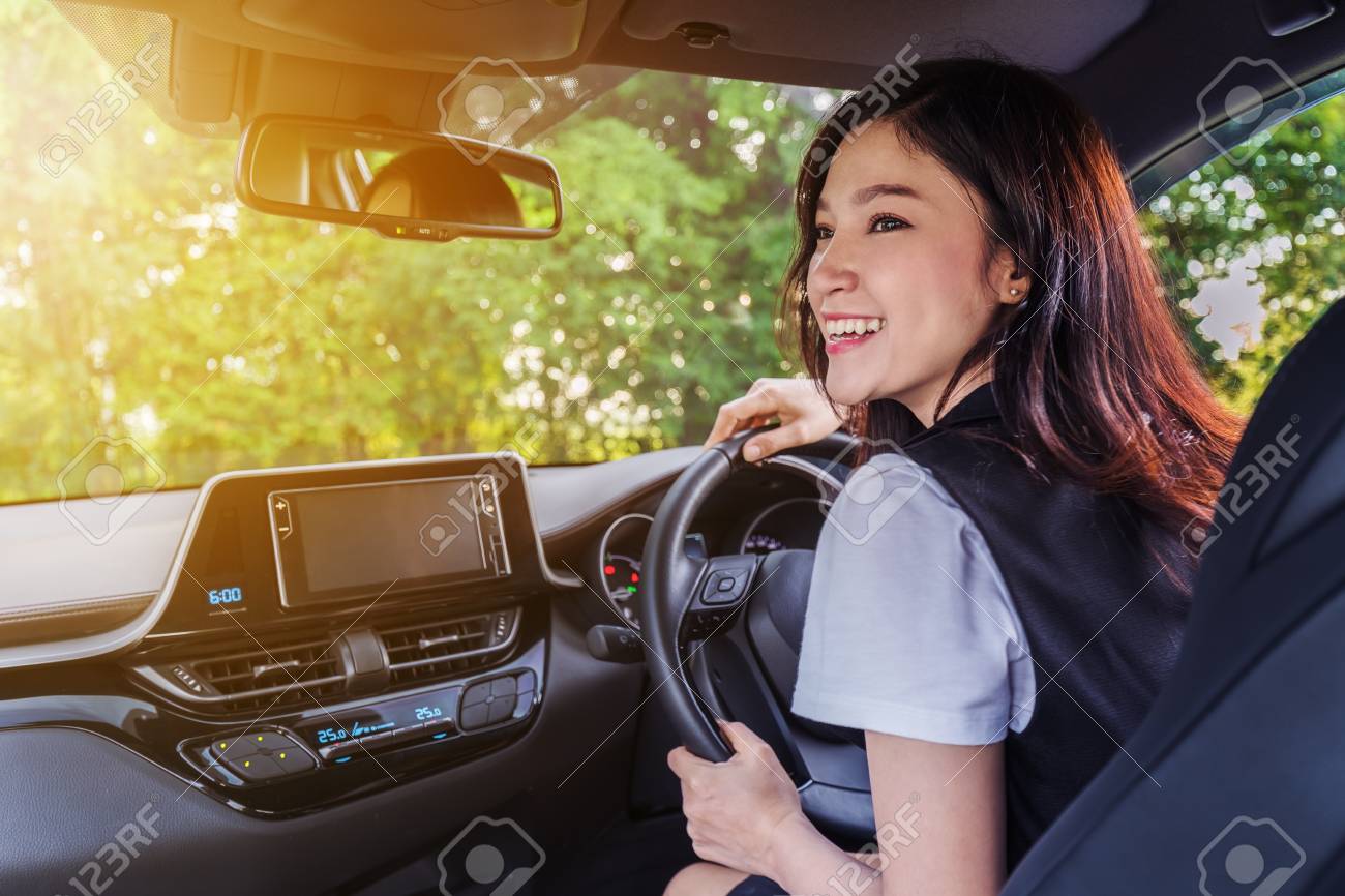 happy young woman in a car - 107583164 happy young woman in a car - 107583164