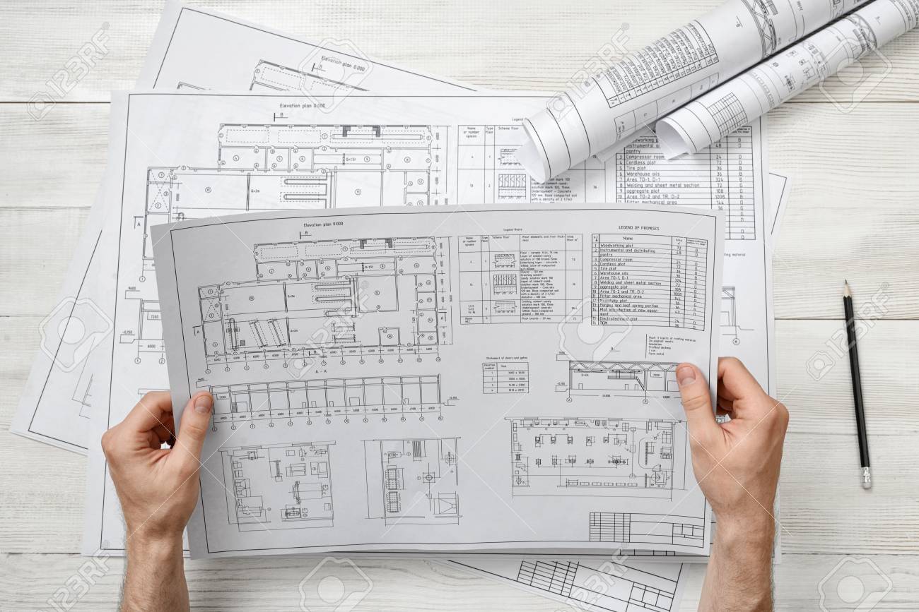 Hands Of Architect Holding A Drawing Sketch Workplace Of Architect Stock Photo Picture And Royalty Free Image Image 56344568