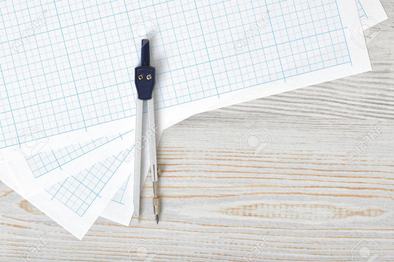 compass on graph paper in top view with copy space workplace