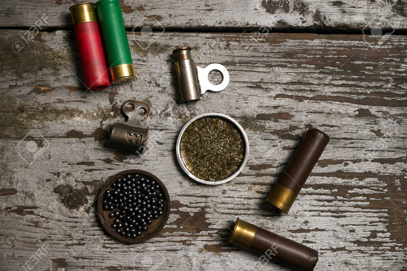 Hunting Equipment. Shotgun Shells Hunting Cartridges With Gunpowder And  Many Plumbeous Fractions Lead Shot On Wooden Table Background, Close-up  Stock Photo, Picture And Royalty Free Image. Image 94514921.