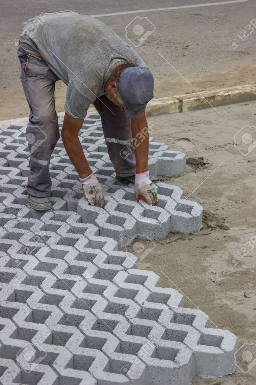 Worker Paving New Parking Places Concrete Grid Pavers Can Be Filled With Soil For Grass Growth Or Aggregate For Drainage Applications Stock Photo Picture And Royalty Free Image Image 23985754