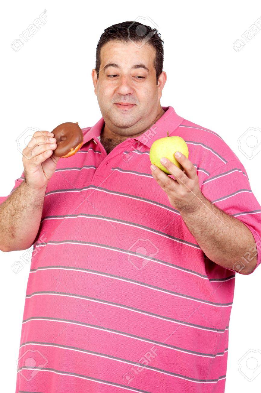 デブ男お菓子と白い背景に分離されたリンゴの間を決定します の写真素材 画像素材 Image