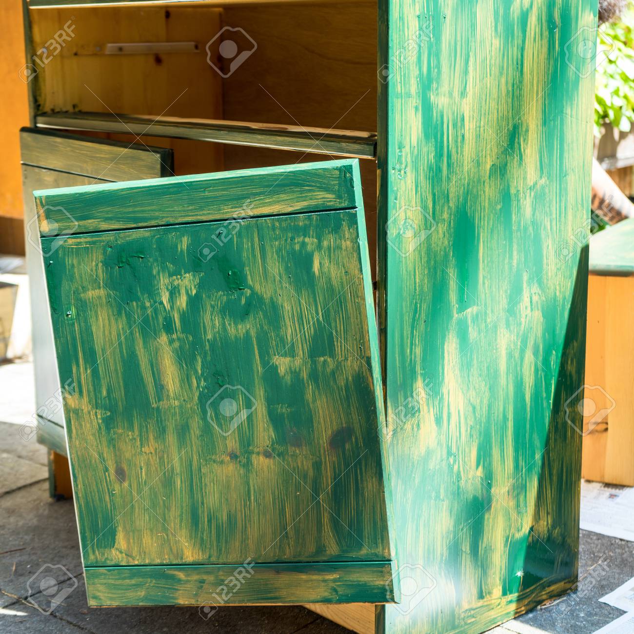 Old Broken Cabinet Which Is Prepared With A First Coat Of Green