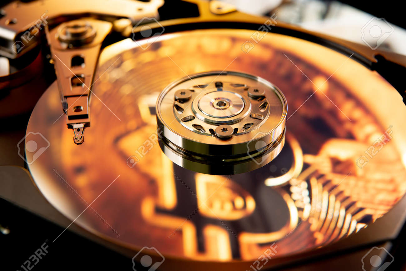 Inside Of An Open Computer Hard Drive With The Projected Bitcoin Symbol  Stock Photo, Picture and Royalty Free Image. Image 170737376.