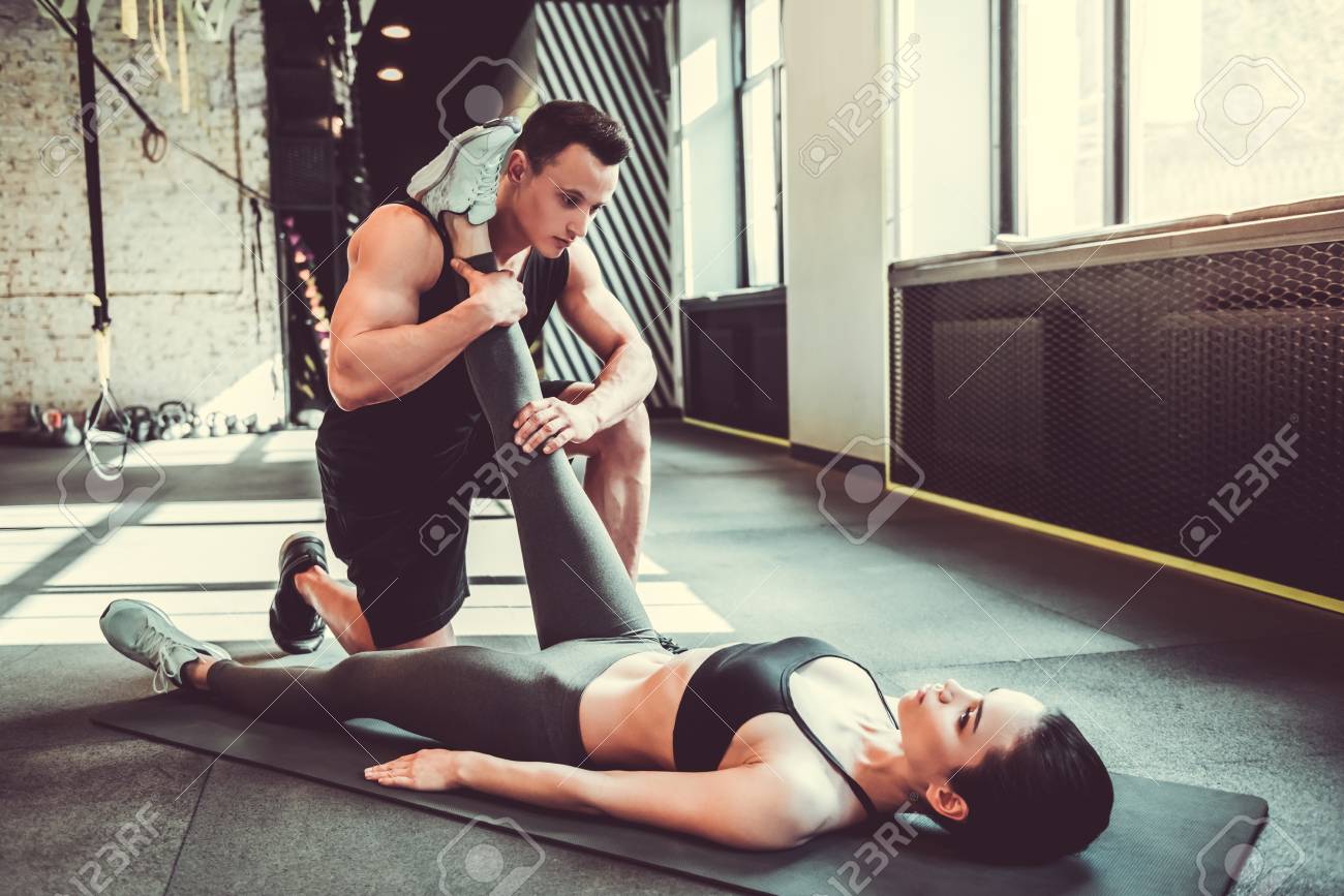 Beautiful Young Sports Couple Is Stretching After Workout In Stock Photo Picture And Royalty Free Image Image