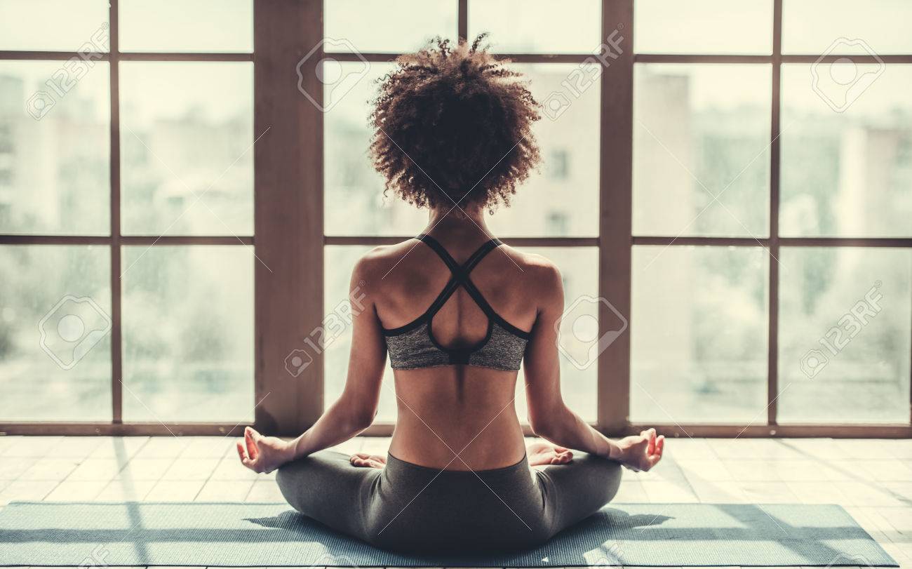 Back view of attractive Afro American girl in sportswear sitting in lotus position while doing yoga - 81369667 Back view of attractive Afro American girl in sportswear sitting in lotus position while doing yoga - 81369667