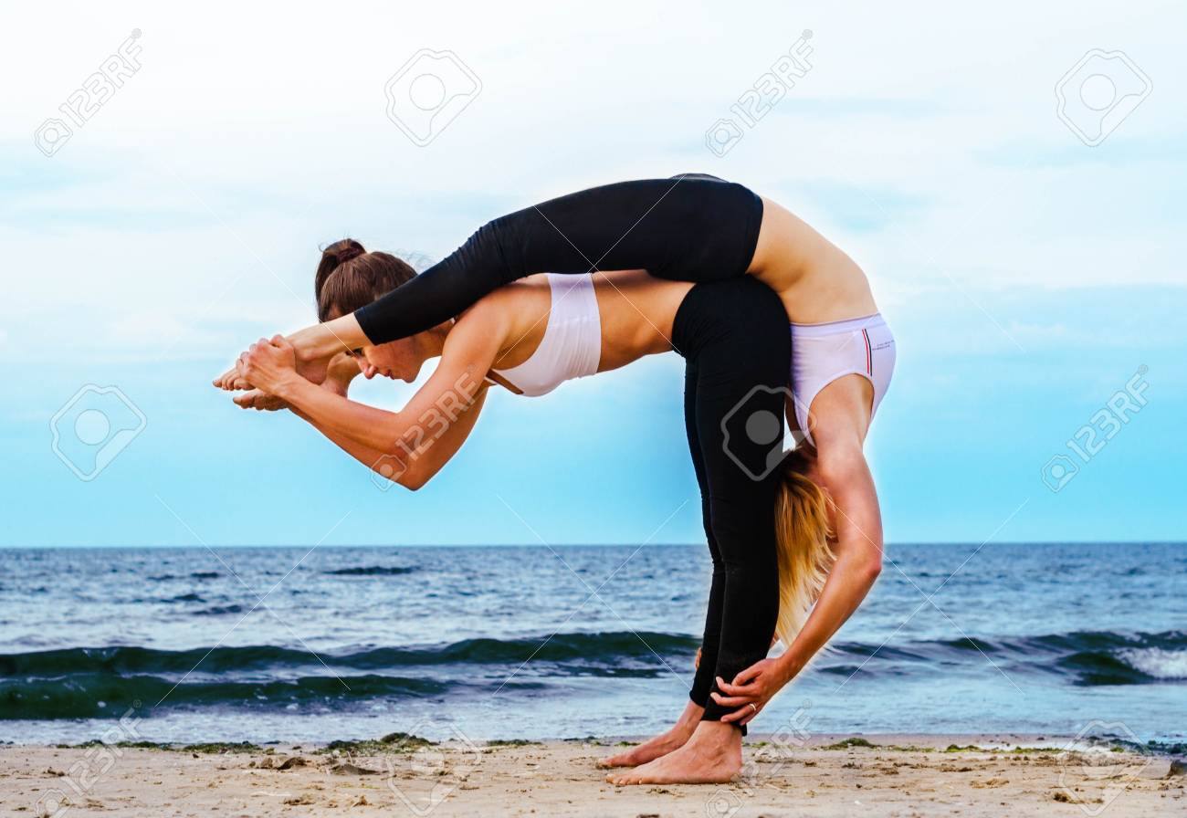 Two Young Women On The Beach In A Paired Acrobatic Yoga Pose Stock Photo Picture And Royalty Free Image Image 107661634