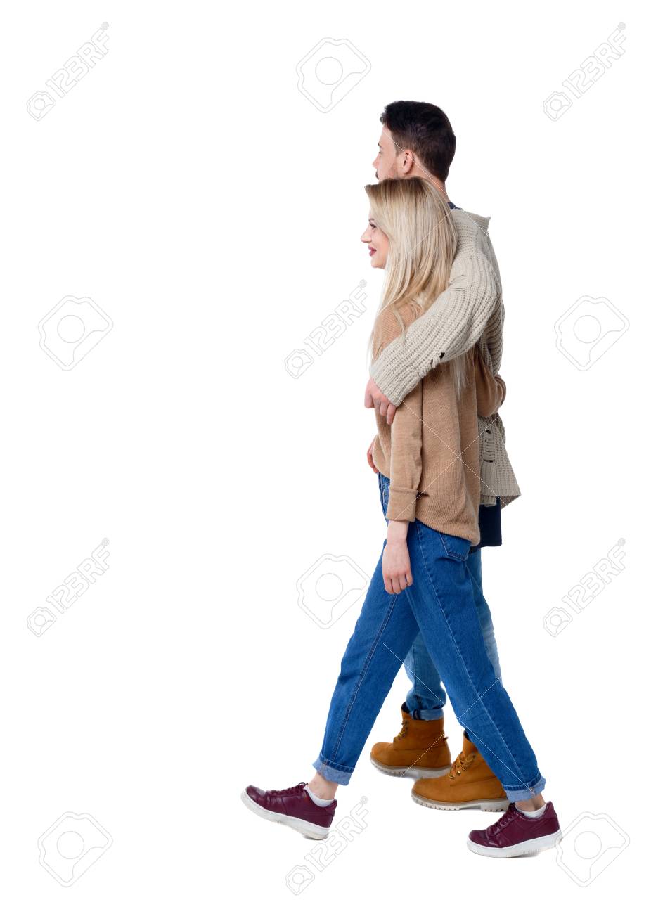 Side View Of Going Couple. Walking Friendly Girl And Guy Holding Hands.  Rear View People Collection. Backside View Of Person. Isolated Over White  Background. Closely Embracing A Young Couple Walks Into The, image size:926x1300