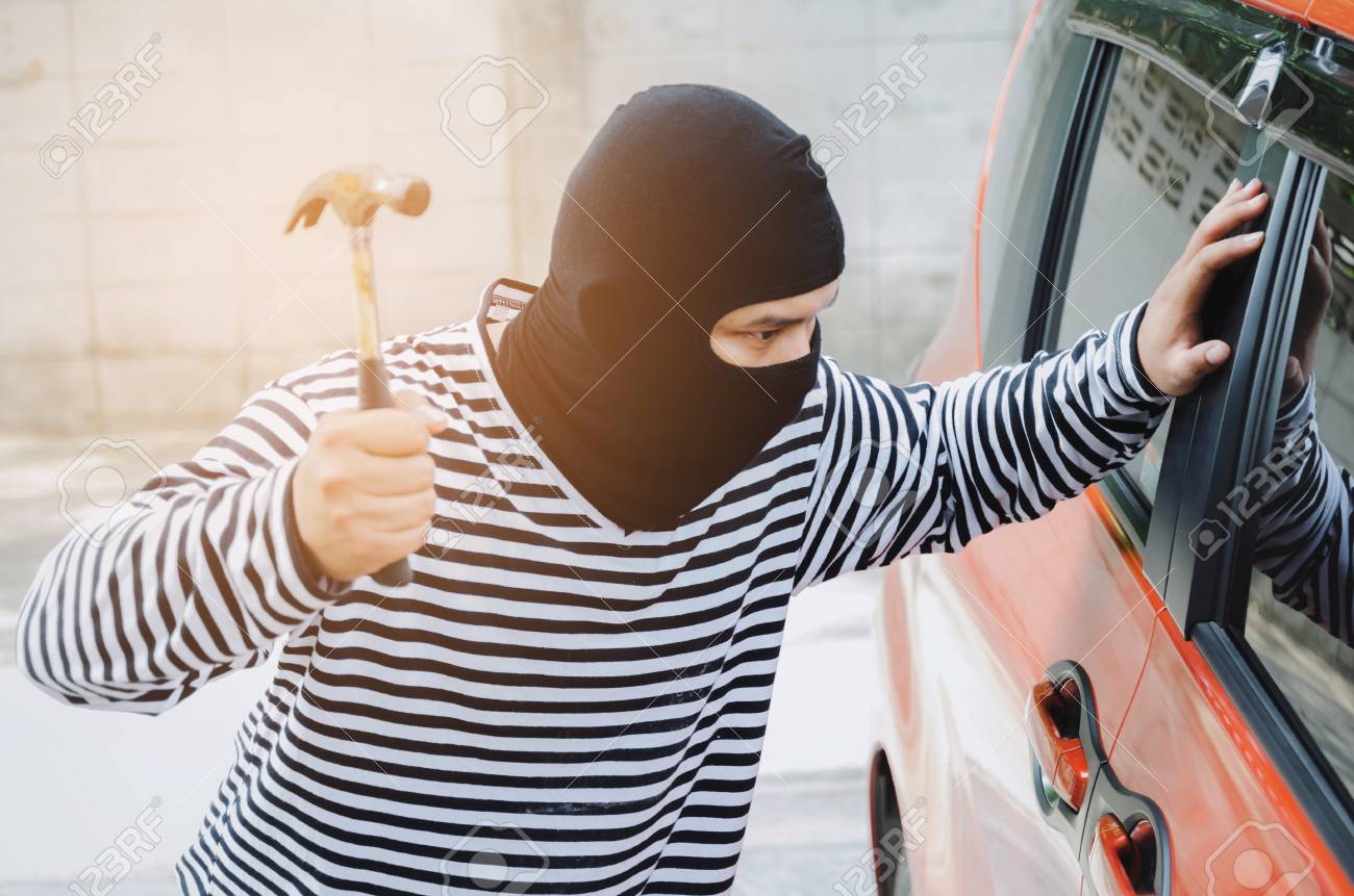 Thief In Black And White Jacket Using Hammer To Smashing Car Door Window To Stealing A Car Break Into The Car Crime Robber And Steal Concept Stock Photo Picture And Royalty Free