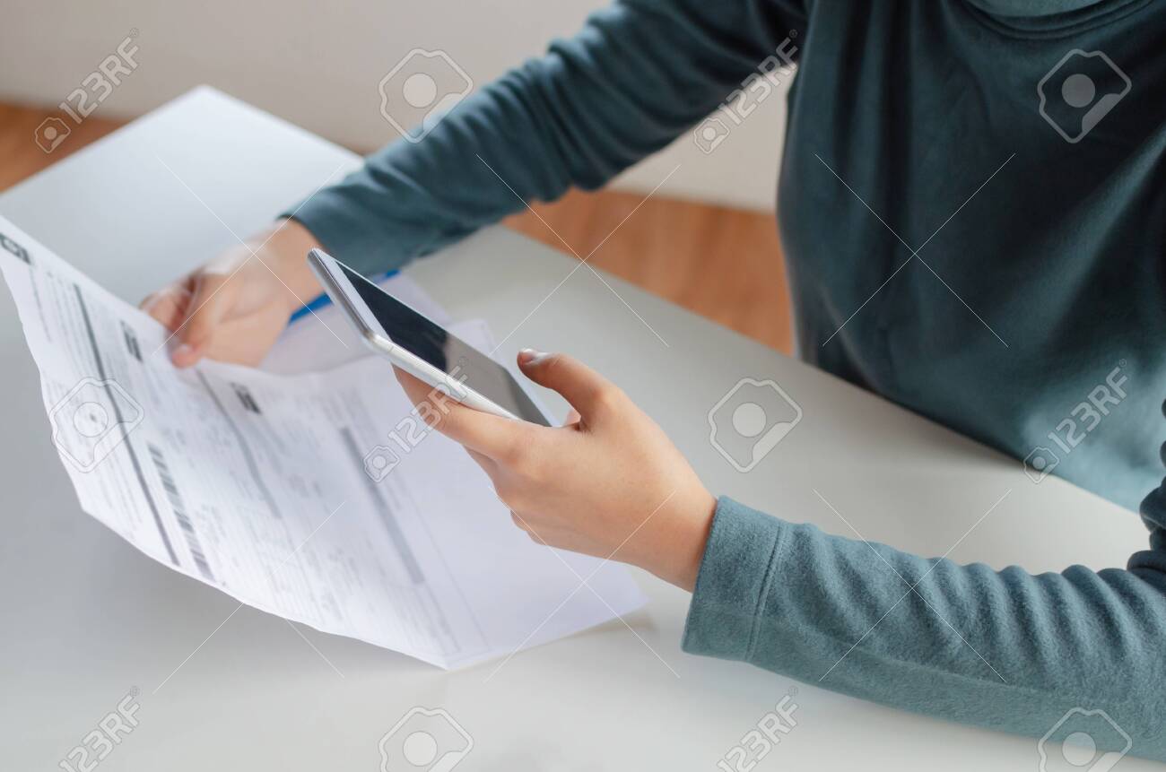 hands of young woman using mobile smart phone for scan and payment online family budget