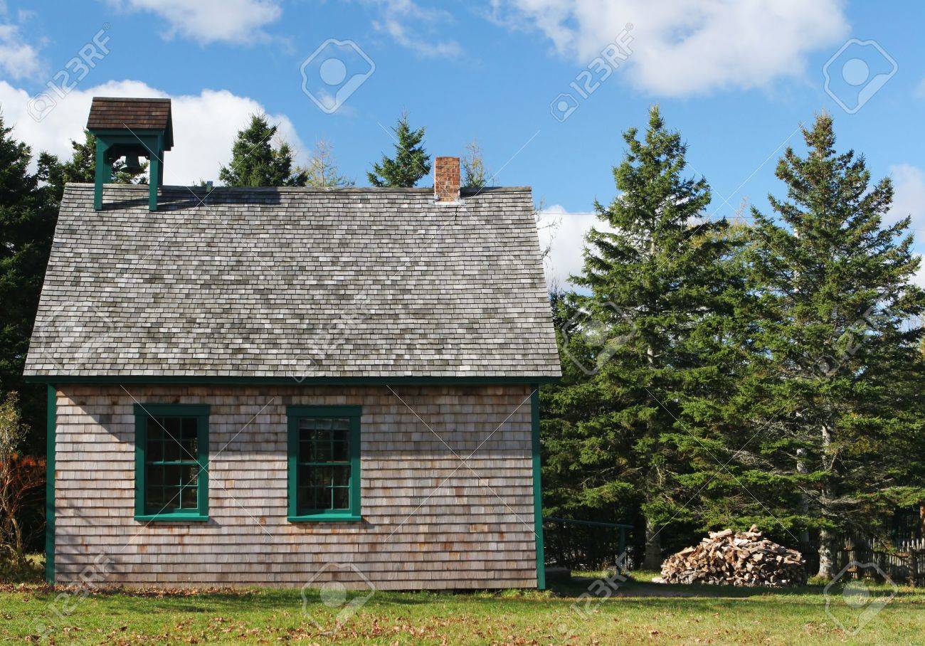 old fashioned school house with fire wood piled up outside stock old fashioned school house with fire wood piled up outside stock