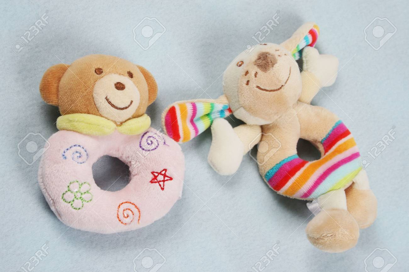 Two Cute Baby Rattles On A Baby Blanket Stock Photo Picture And