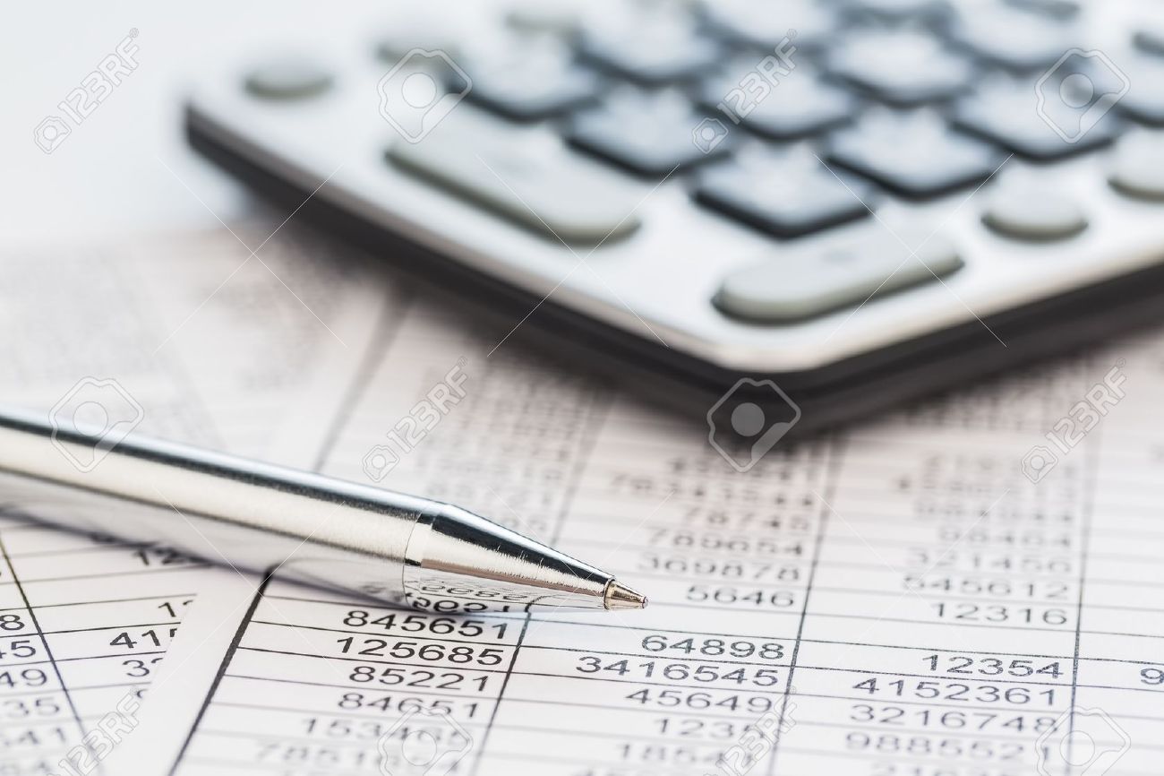 a calculator is on a balance sheet numbers are statistics photo