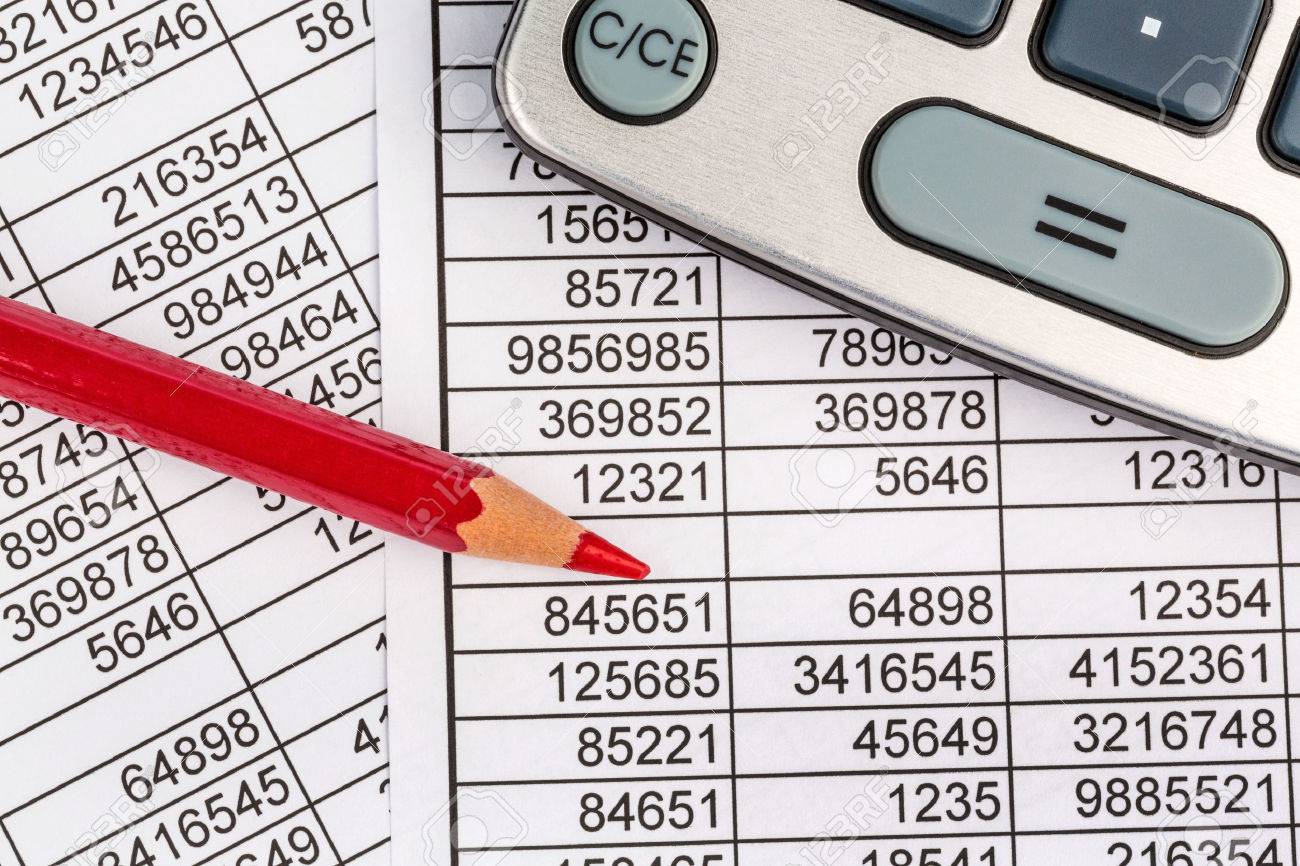 a calculator is on a balance sheet figures are statistics photo
