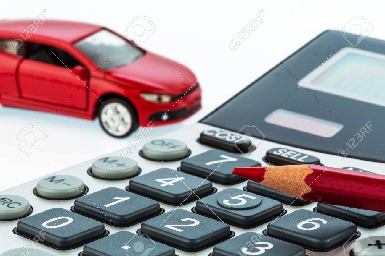 a car and a red pen is on a calculator cost of gasoline wear