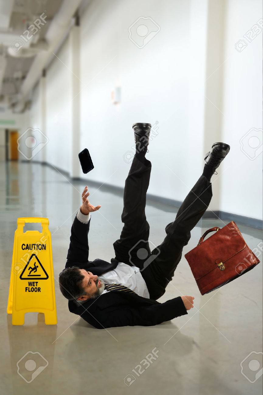 Mature businessman falling on wet floor inside building hallway - 31850669 Mature businessman falling on wet floor inside building hallway - 31850669