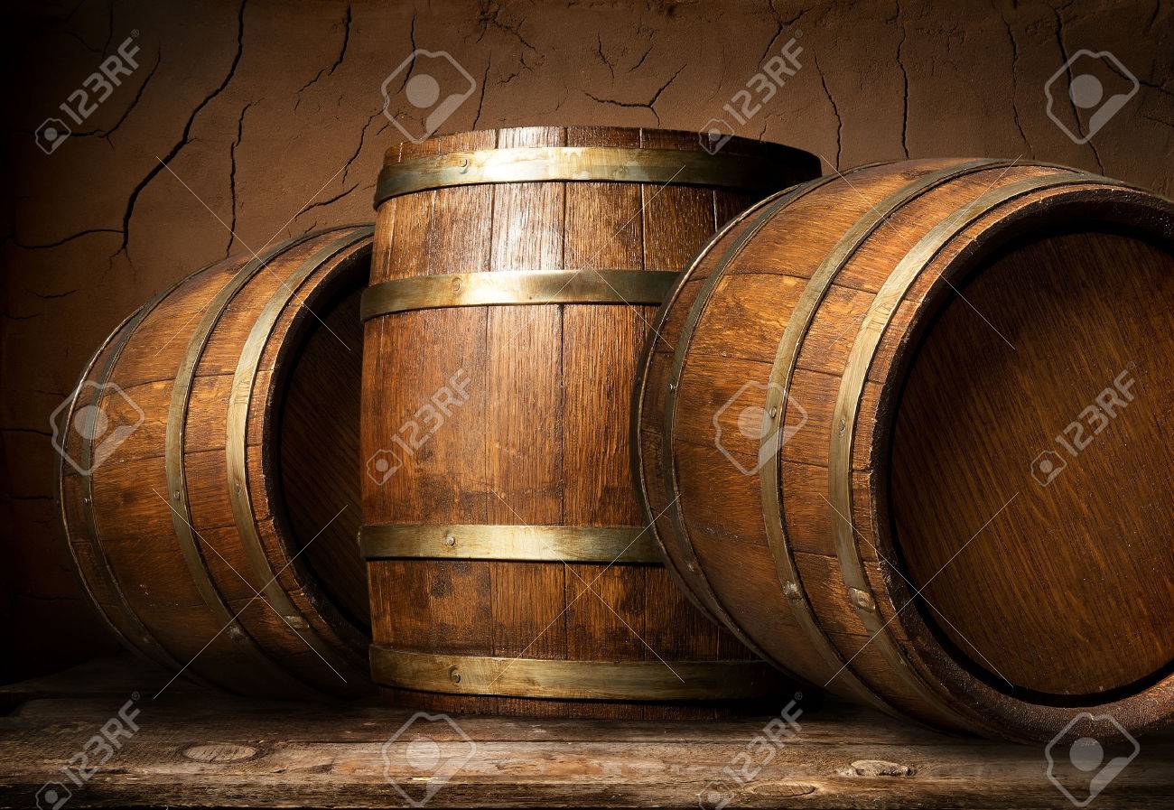 Old wooden barrels in cellar with clay wall - 54300853 Old wooden barrels in cellar with clay wall - 54300853
