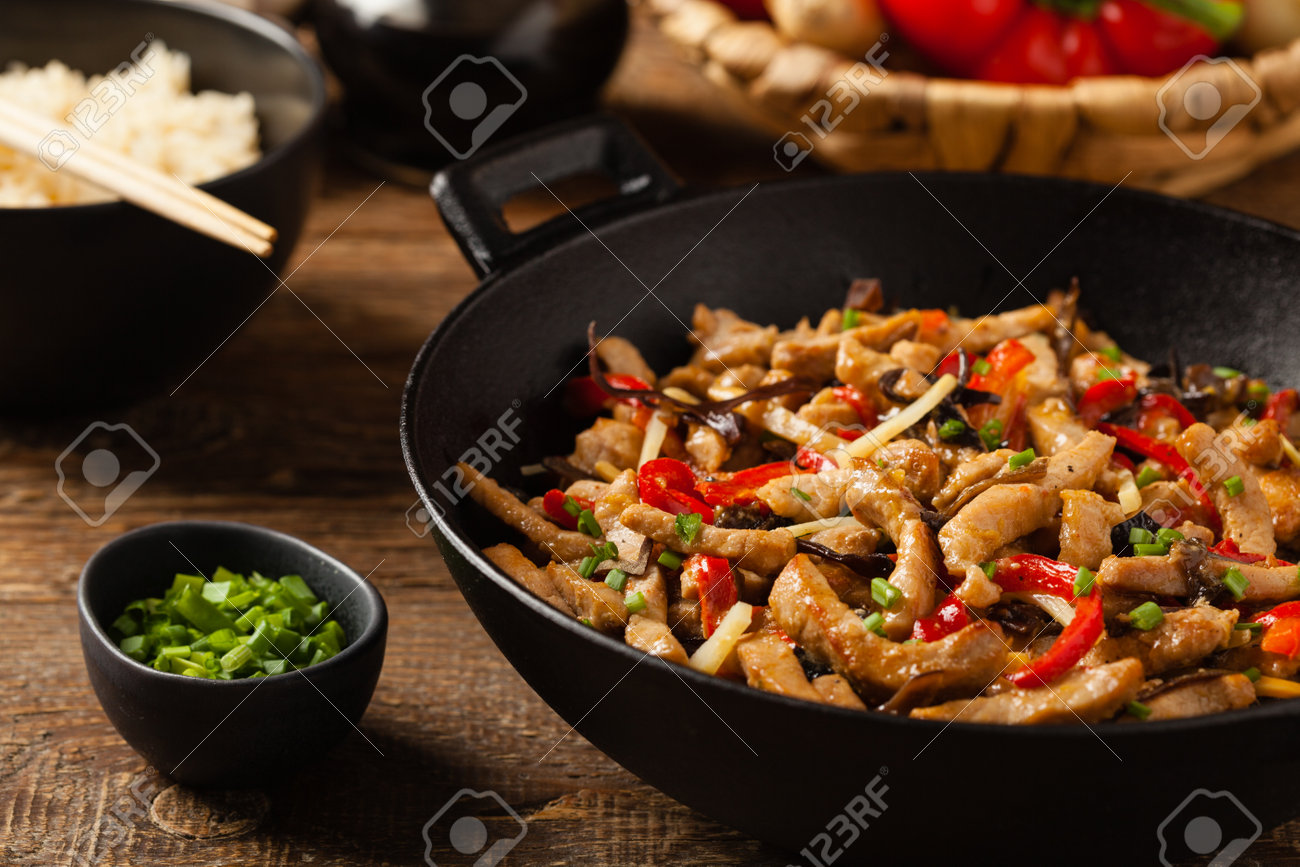 Pork chop with peppers, mushrooms and bamboo. Served with rice. Front view. - 168376713 Pork chop with peppers, mushrooms and bamboo. Served with rice. Front view. - 168376713