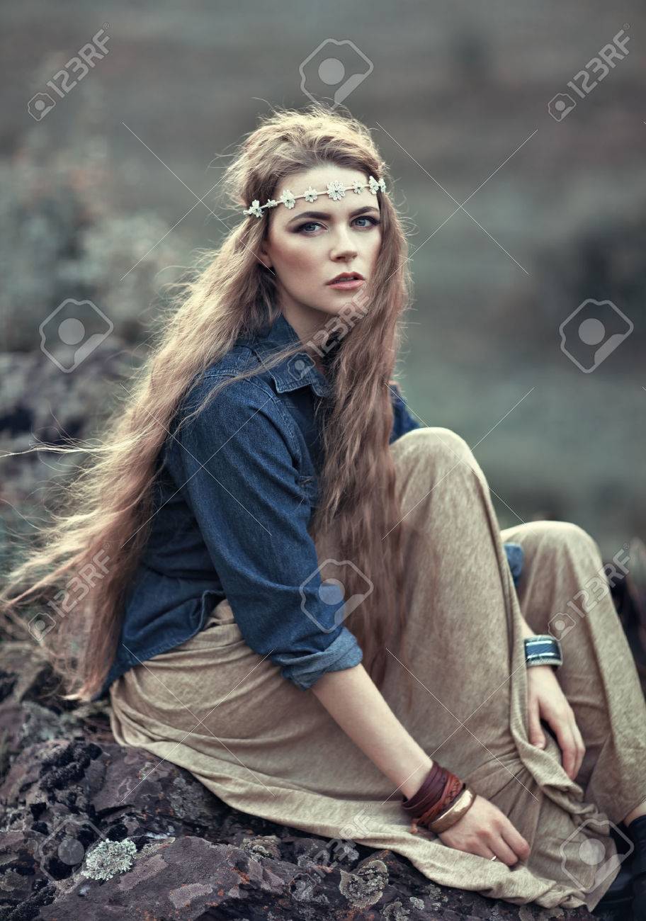 Beautiful hippie girl sitting on stone. Boho fashion style - 32467105 Beautiful hippie girl sitting on stone. Boho fashion style - 32467105