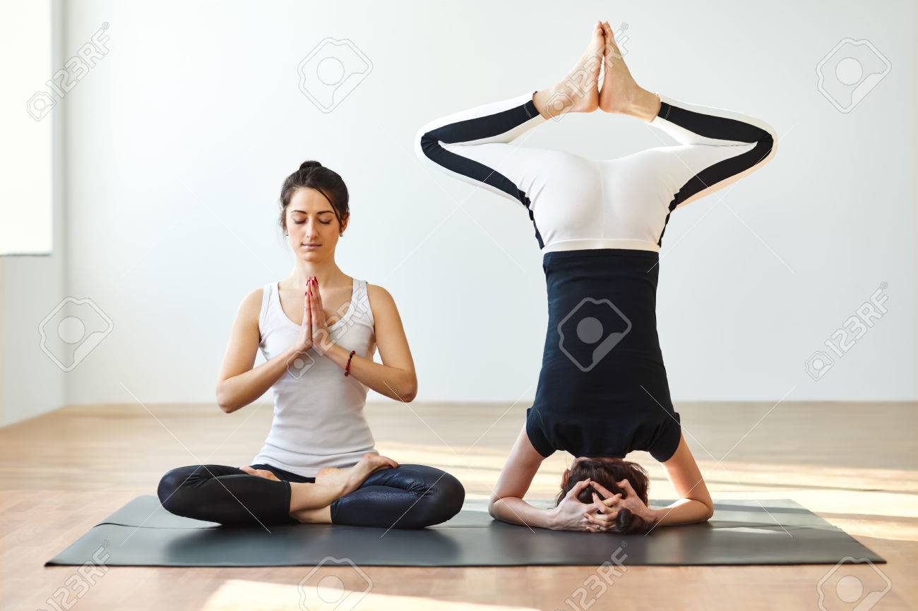 Two young women practicing yoga poses and asanas. Partner yoga Two young women practicing yoga poses and asanas. Partner yoga