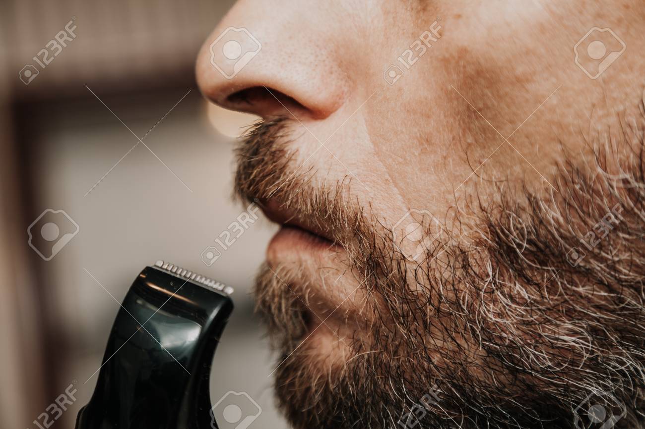 Haircut Beard Trimmer A Man Cuts His Mustache With A Machine