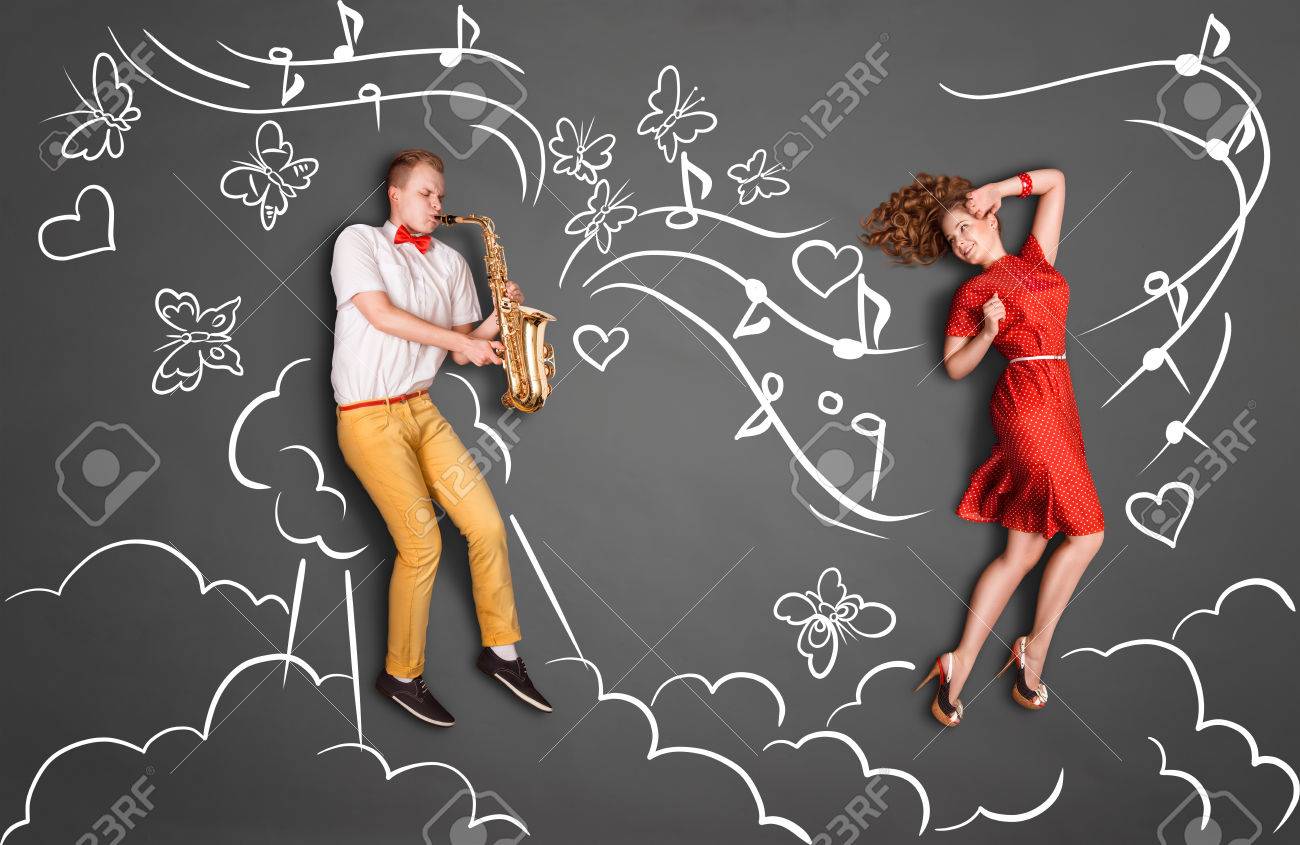 Love Story Concept Of A Romantic Couple Against Chalk Drawings Heaven Background. Male Playing The Sax For His Girlfriend. Stock Photo, Picture and Royalty Free Image. Image 41249264.