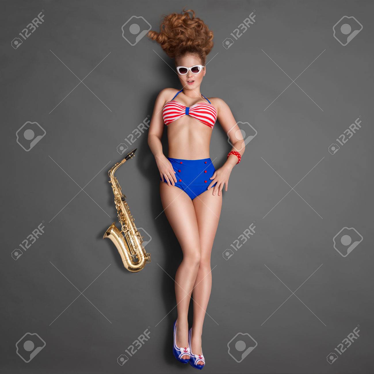 Top View Of A Beautiful Pin Up Girl In Retro Bikini And Sunglasses Posing With A Gold Jazz Saxophone On Chalkboard Background Stock Photo Picture And Royalty Free Image Image Top View Of A Beautiful Pin Up Girl In Retro Bikini And Sunglasses Posing With A Gold Jazz Saxophone On Chalkboard Background Stock Photo Picture And Royalty Free Image Image