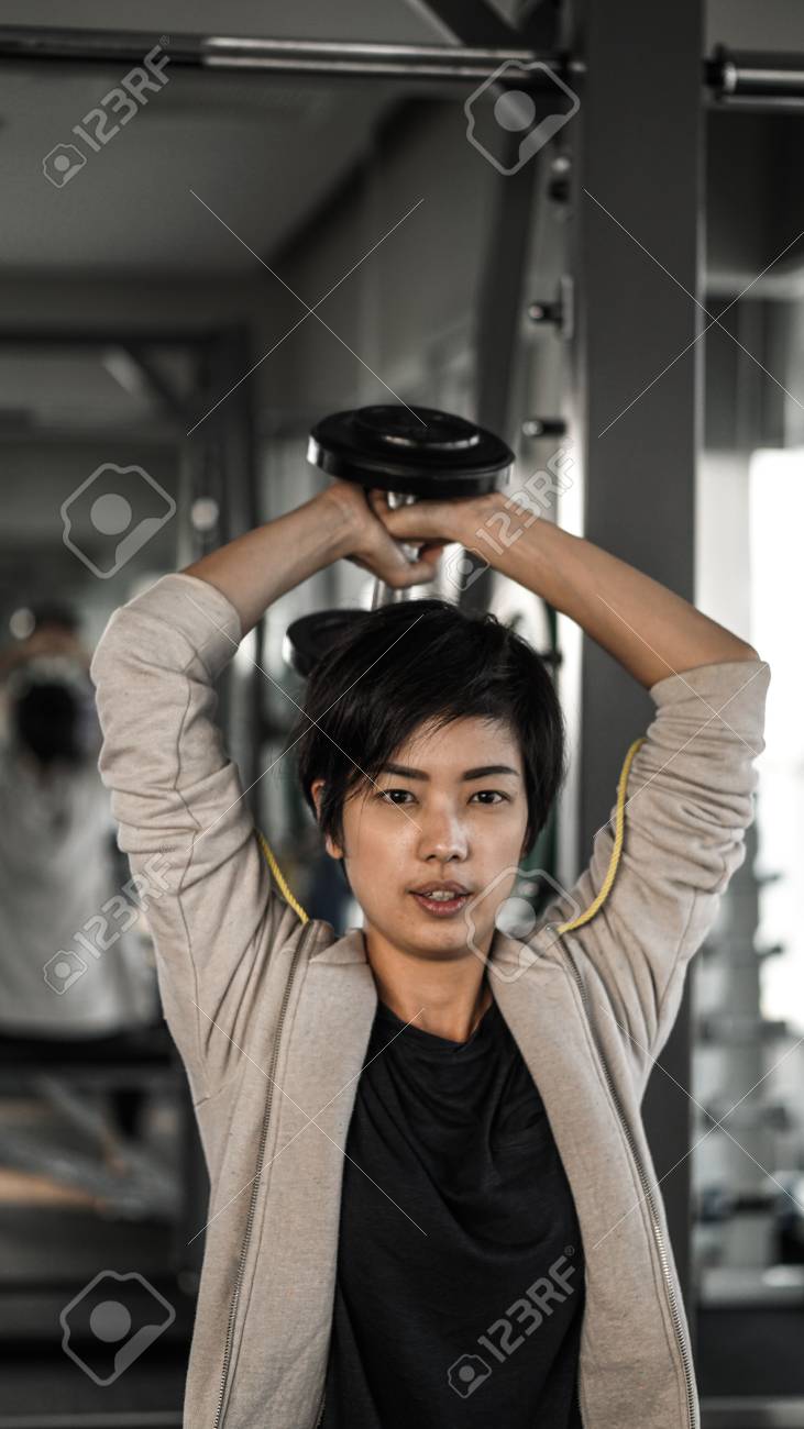 Smiling Asian Short Hair Woman Fitness Dumbbell Lifting Healthy