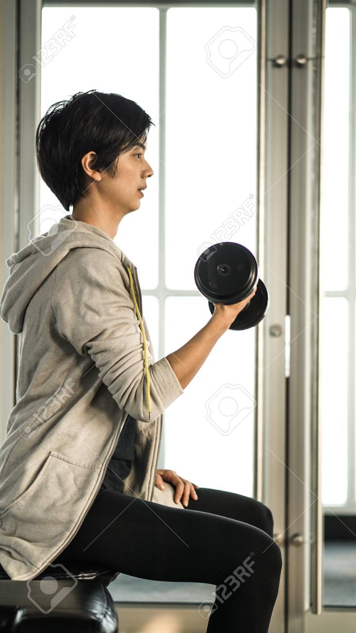 Smiling Asian Short Hair Woman Fitness Dumbbell Lifting Healthy