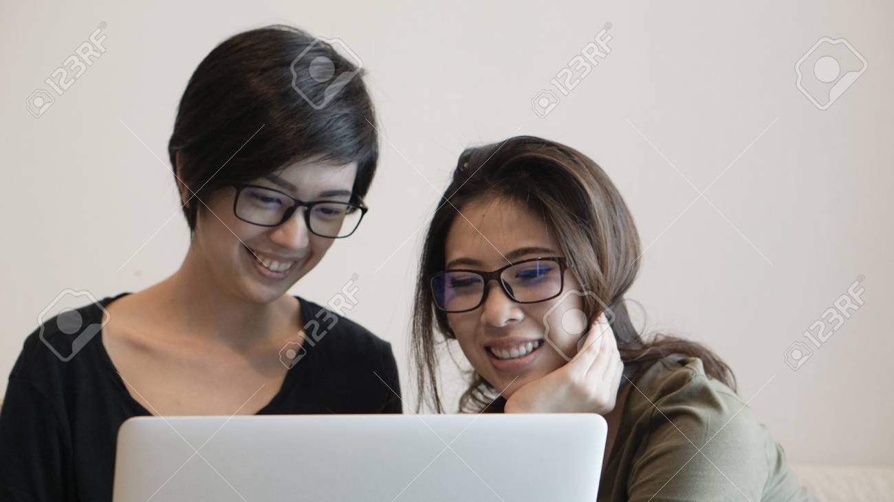 Mixed race Asian girls using computer for business - 125468927 Mixed race Asian girls using computer for business - 125468927