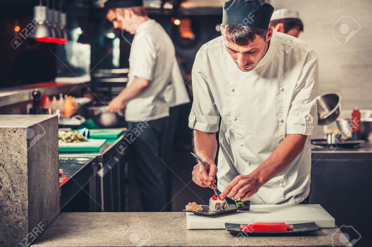 Male Cooks Preparing Sushi In The Restaurant Kitchen Stock Photo Picture And Royalty Free Image Image