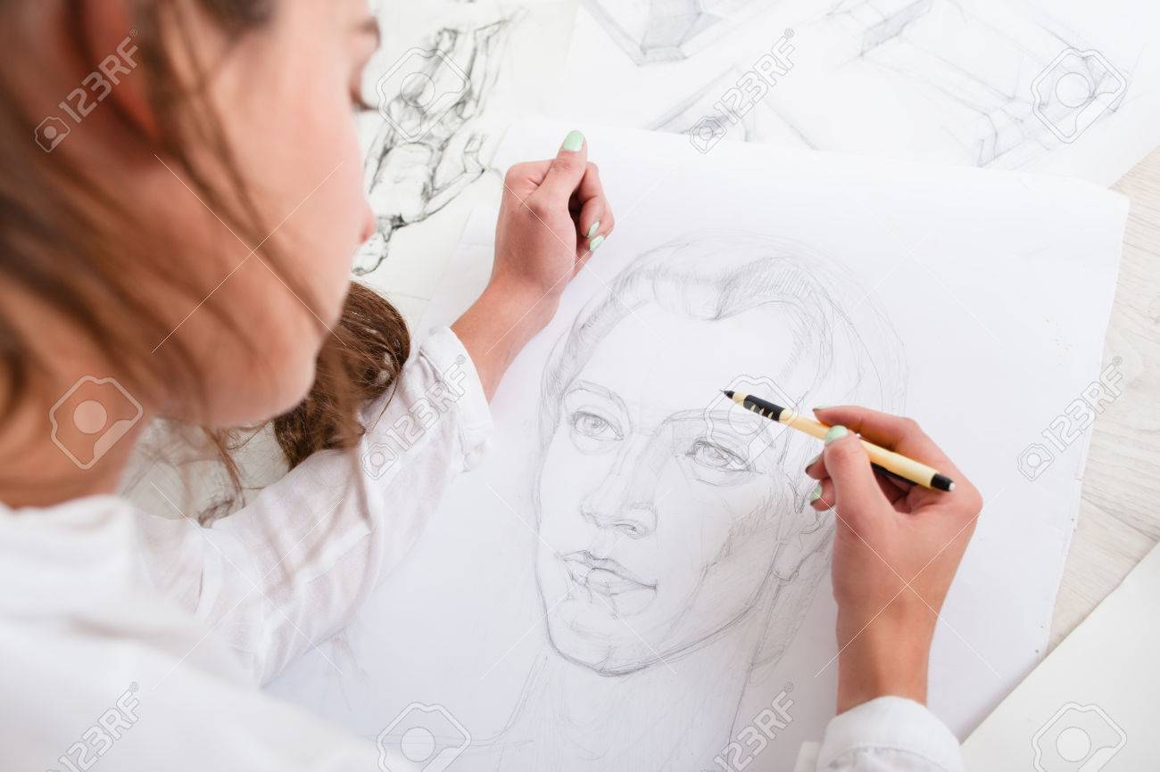 Artist drawing pencil portrait close-up. Woman painter creating picture of woman on big whatman. Art, talent, craft, hobby, occupation concept - 67217671 Artist drawing pencil portrait close-up. Woman painter creating picture of woman on big whatman. Art, talent, craft, hobby, occupation concept - 67217671