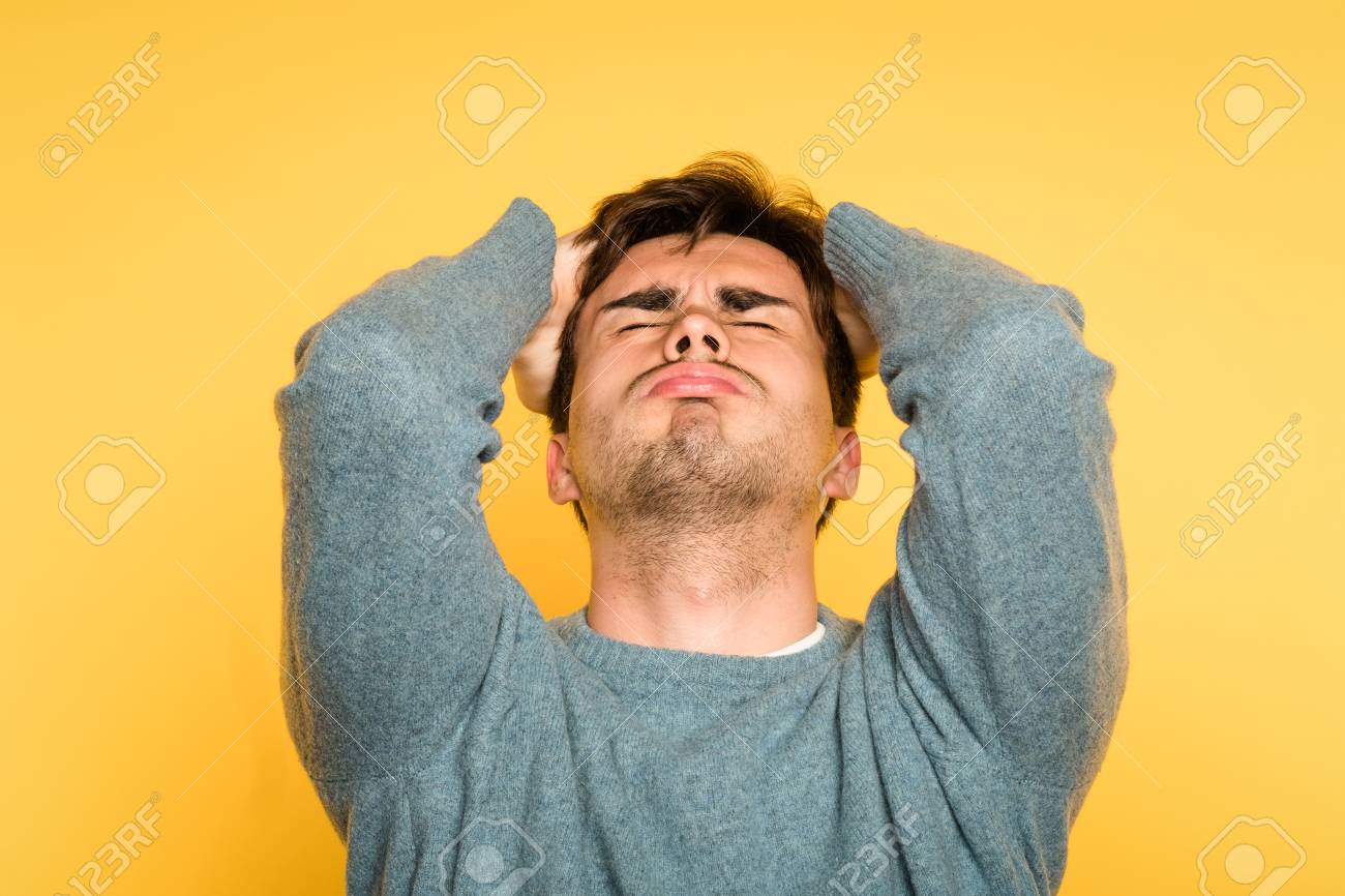 Devastated Stricken Man In Despair. Failure And Loss Concept. Portrait Of A  Young Brunet Guy On Yellow Background. Emotion Facial Expression. Feelings  And People Reaction. Stock Photo, Picture And Royalty Free Image.