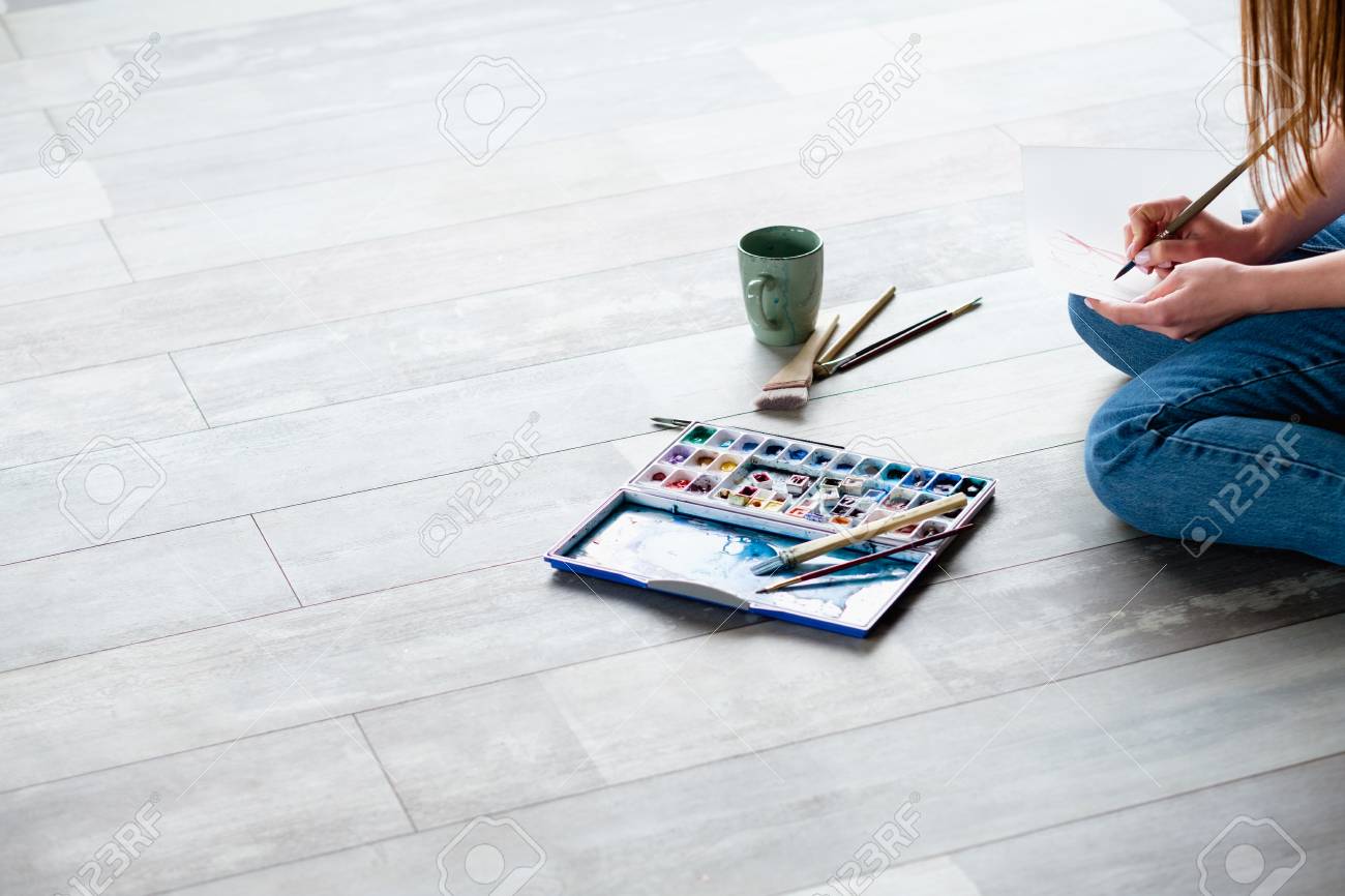 creative leisure. painting hobby. artful personality. talented artist drawing sitting on the floor. - 105713607 creative leisure. painting hobby. artful personality. talented artist drawing sitting on the floor. - 105713607