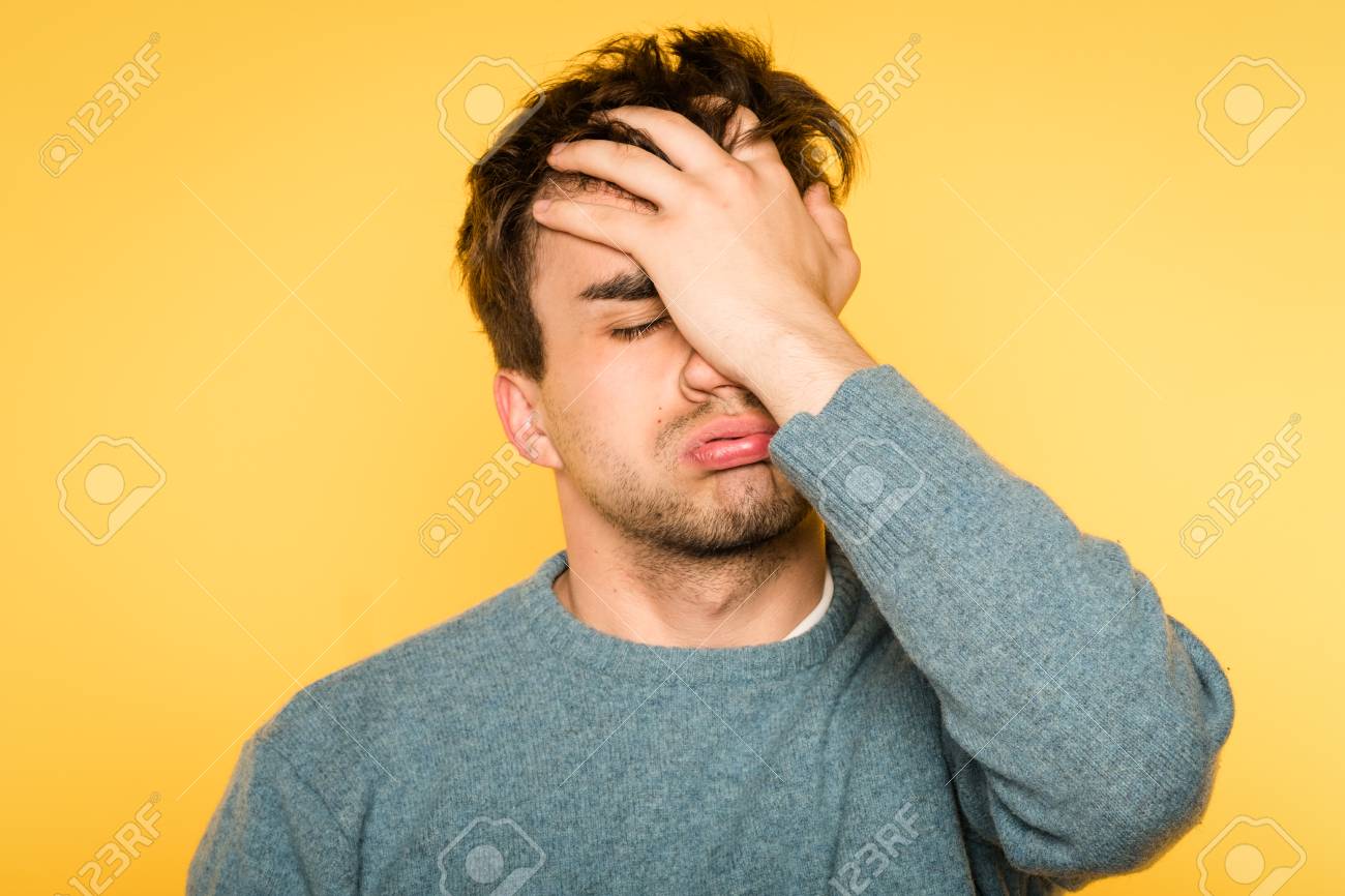 facepalm. desperate frustrated man covering his face. hopeless situation and regret. portrait of a young brunet guy on yellow background. emotion facial expression and feelings concept. - 105869881 facepalm. desperate frustrated man covering his face. hopeless situation and regret. portrait of a young brunet guy on yellow background. emotion facial expression and feelings concept. - 105869881