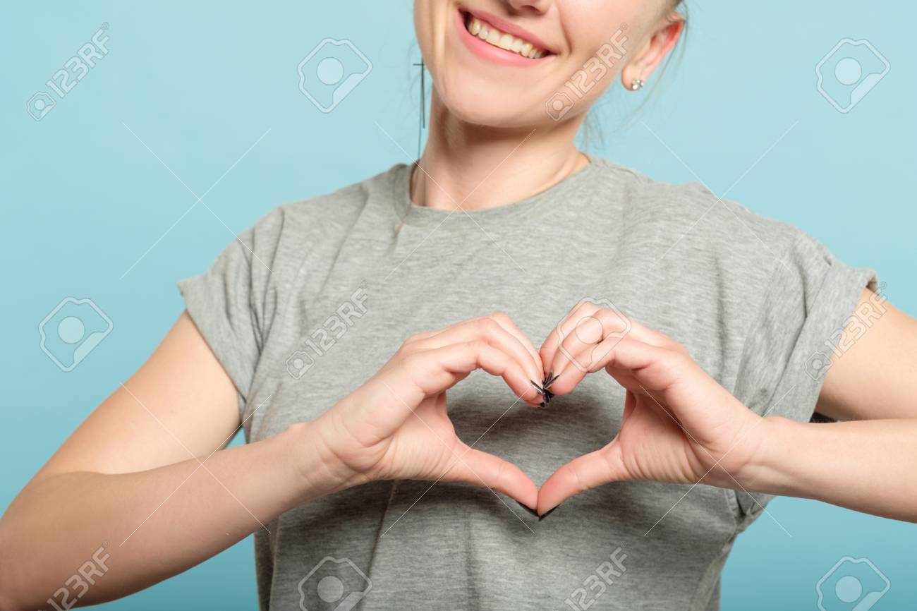smiling woman making a heart shape with her hands. love and feelings expression. - 111518393 smiling woman making a heart shape with her hands. love and feelings expression. - 111518393