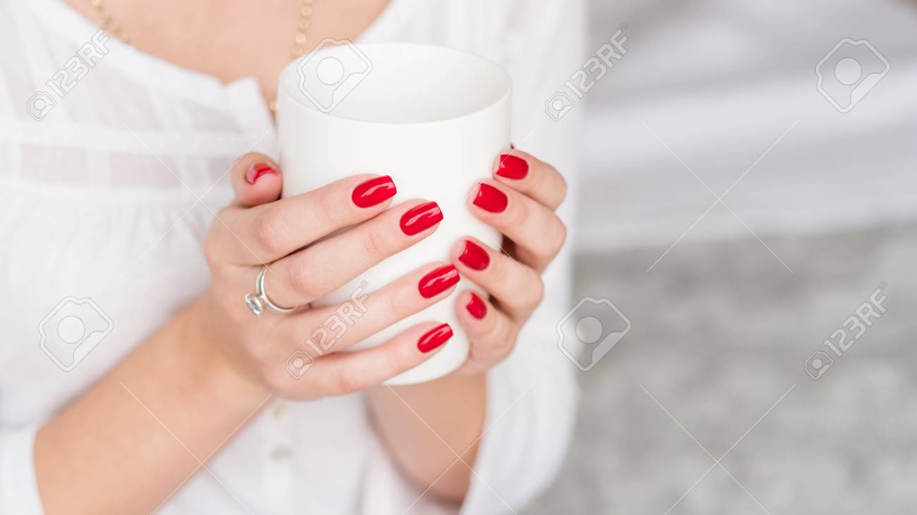 Wake up beverage. Woman manicured hands with white cup of hot morning drink. - 117037842 Wake up beverage. Woman manicured hands with white cup of hot morning drink. - 117037842
